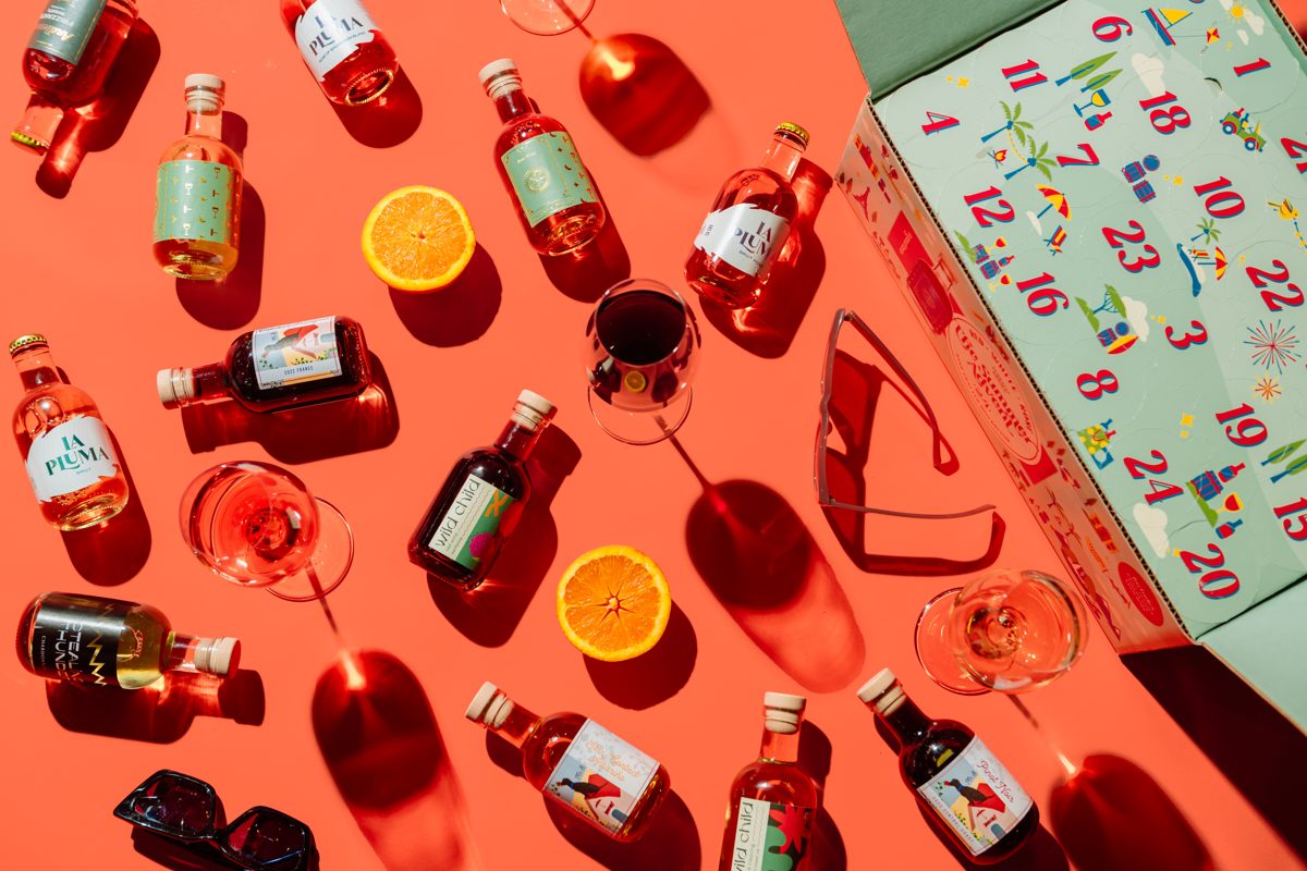 Mini wine bottles and glasses on a red table